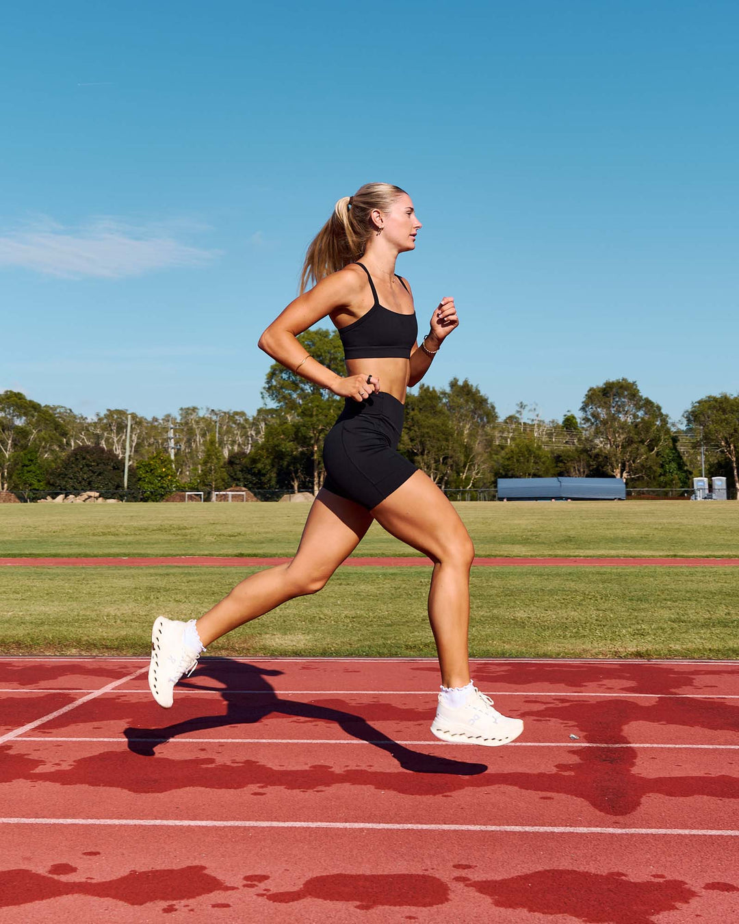 Woman wearing Elite Run High-Rise 5" Short Pockets - Black | Model:Emelia | Size:S