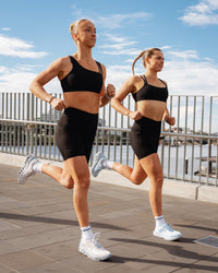 Woman wearing Elite Run High-Rise 7" Short Pockets - Black | Model:Both | Size:S