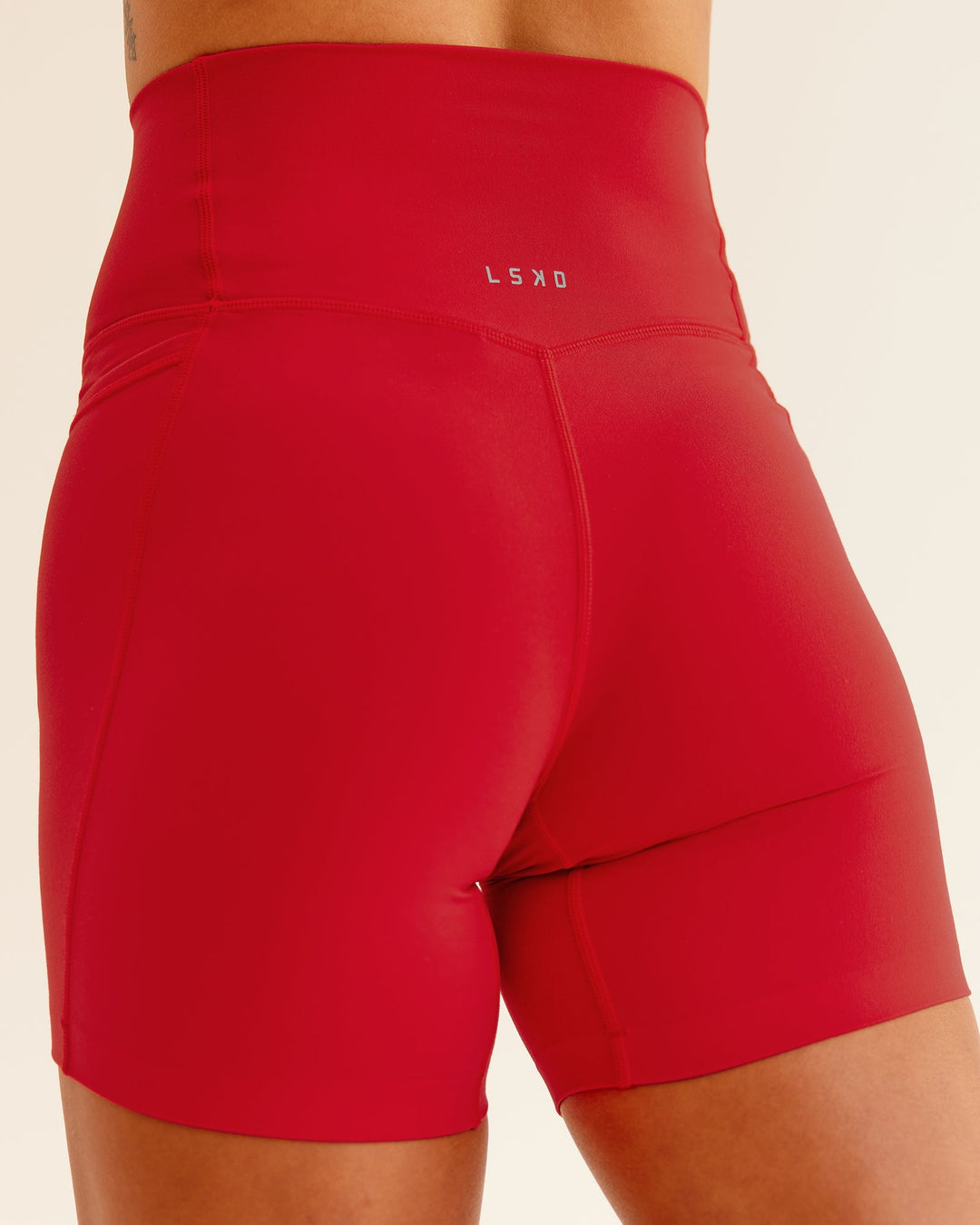 Woman wearing Elixir Mid Short Tight With Pockets in Flame | Size:S