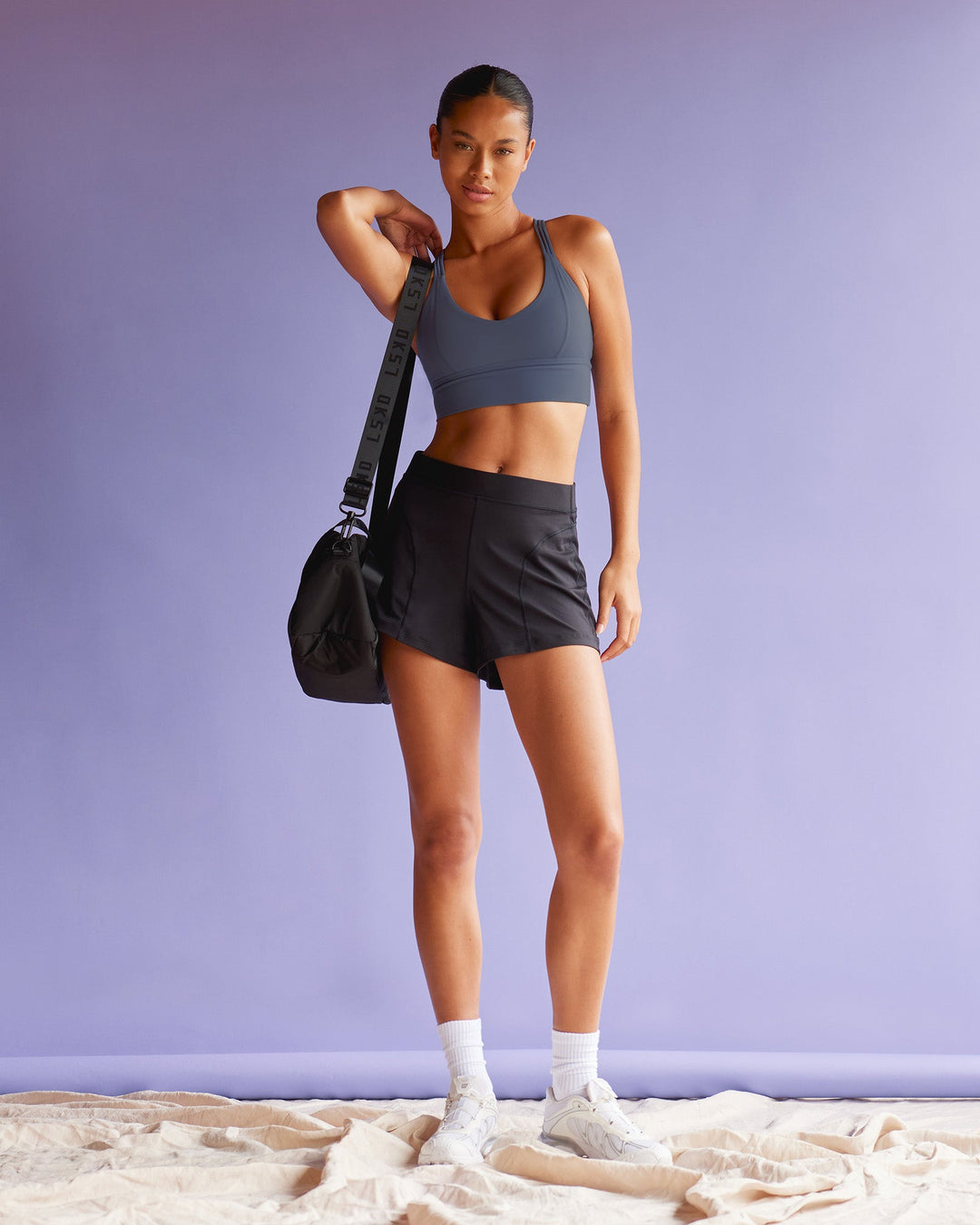 Woman wearing Flash Longline Sports Bra - Night Shadow | Model:Tali | Size:S