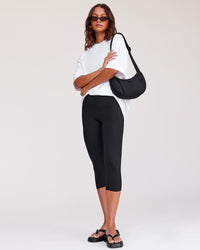 Woman wearing Fusion Ultra High-Rise 3/4 Legging Pockets - Black | Model:Kirstyn | Size:S