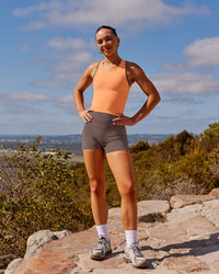 Woman wearing Fusion Ultra High-Rise 4" Short Pockets - Peppercorn | Model:Rica | Size:S