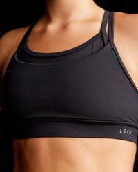 Woman wearing Genesis Layered Sports Bra - Black | Size:S | Thumbnail Index: 0