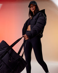 Woman wearing Go-To Puffer Jacket - Black | Model:Rhiley | Size:S