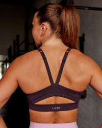 Woman wearing Momentum Sports Bra - Midnight Plum | Model:Roisin | Size:S