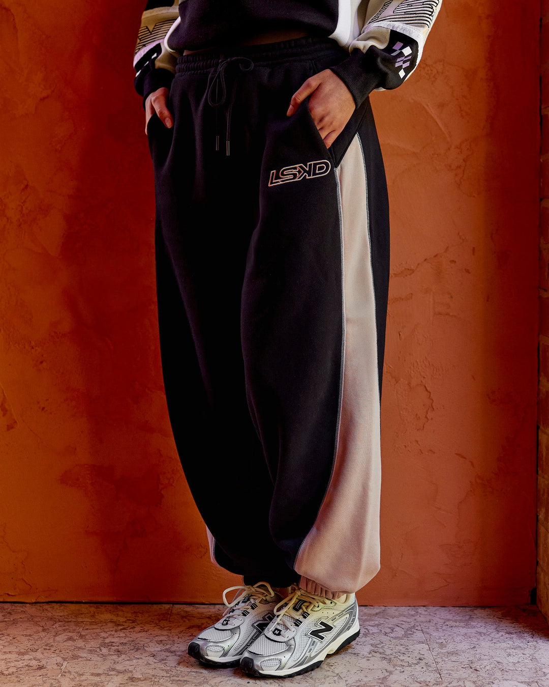 Woman wearing Power Play Stitch Up Fleece Sweat Pant - Black-Shale Beige | Model:Shae | Size:S
