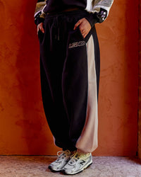 Woman wearing Power Play Stitch Up Fleece Sweat Pant - Black-Shale Beige | Model:Shae | Size:S