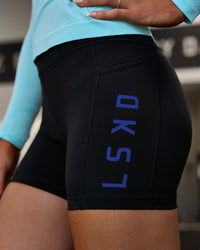 Woman wearing Rep Ultra High-Rise 4" Short Pockets - Black-Electric Indigo | Model:Emelia | Size:S
