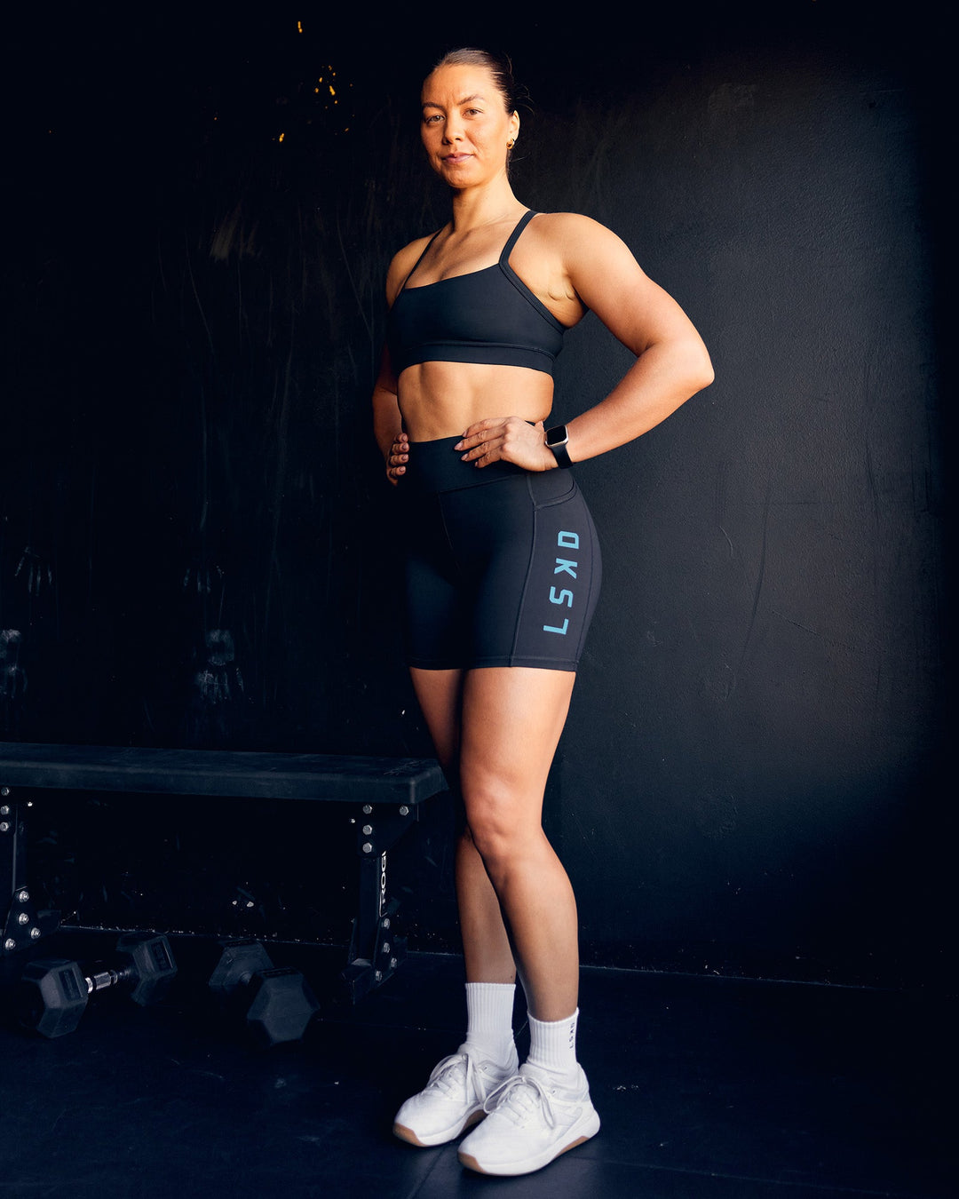 Woman wearing Rep Ultra High-Rise 6&quot; Short Pockets - Black-Blue Atoll | Model:Bailey | Size:S