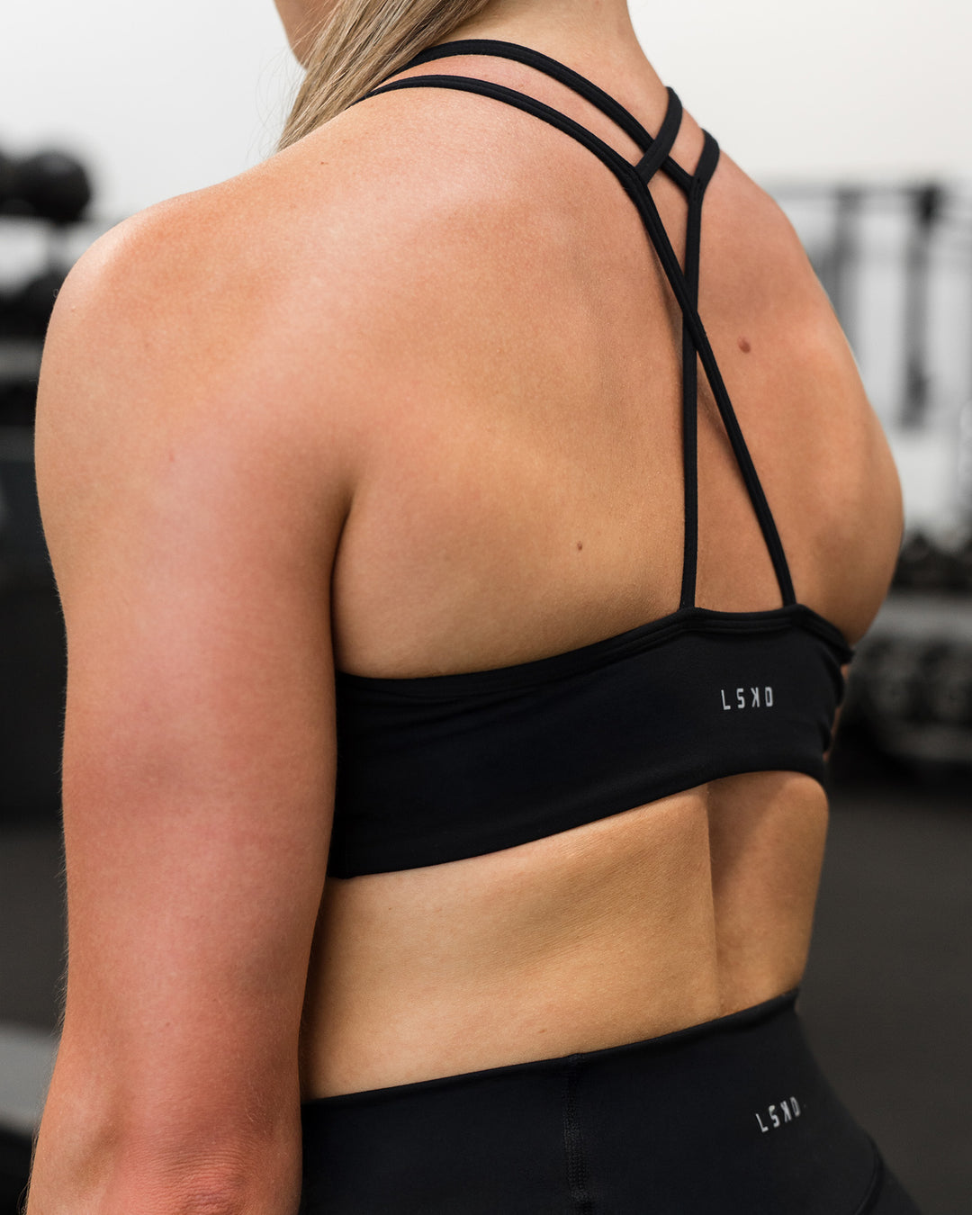 Woman wearing Stamina Pulse Sports Bra - Black | Model:Sarah | Size:S