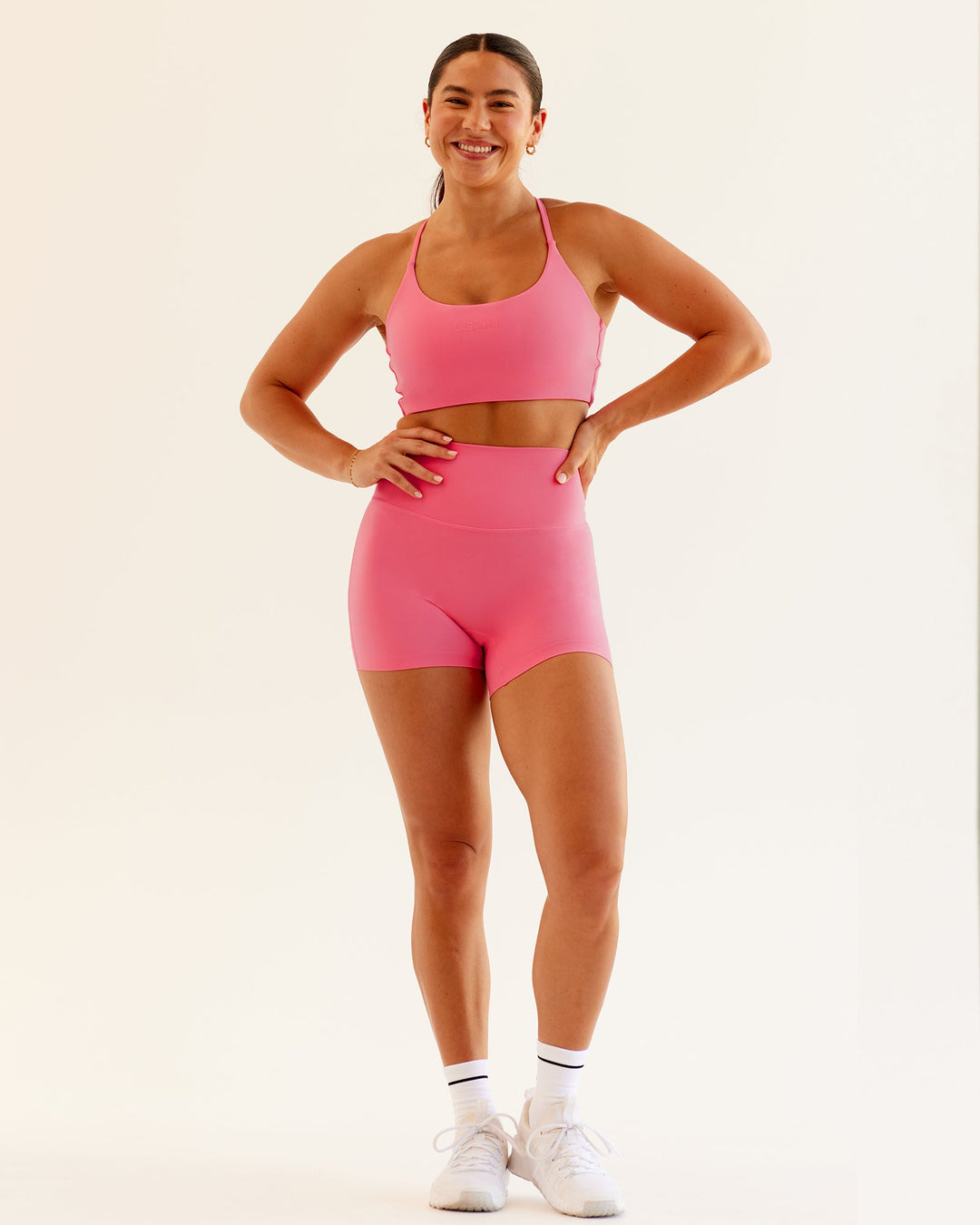 Woman wearing Twist Sports Bra in Pink Lemonade | Size:S