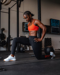 Woman wearing Twist Sports Bra - Ultra Orange | Model:Cebile | Size:S