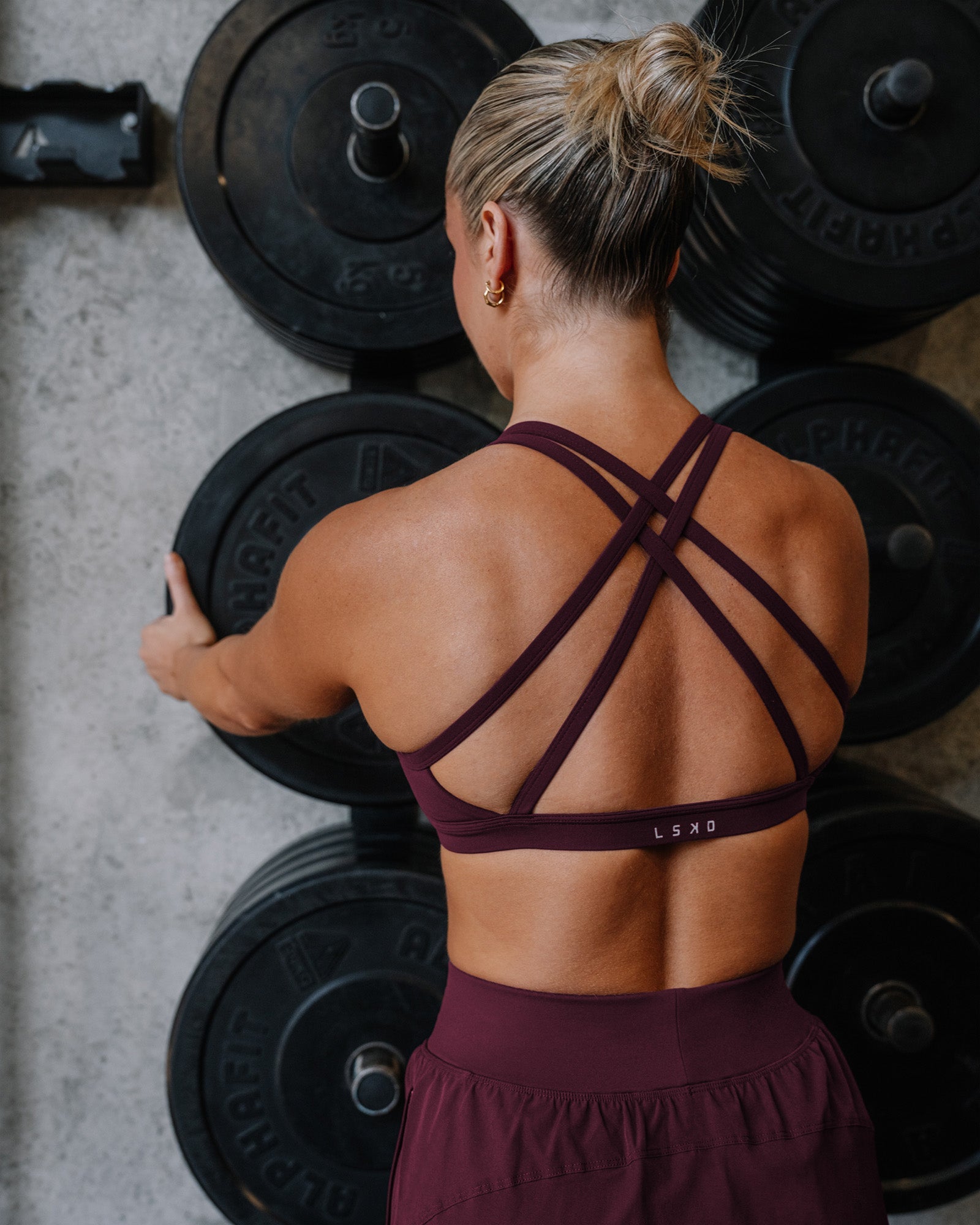 Woman wearing Velocity Sports Bra - Cherry Lacquer | Model:Lyss | Size:S