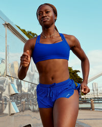Woman wearing Velocity Sports Bra - Electric Indigo | Model:Naa | Size:S