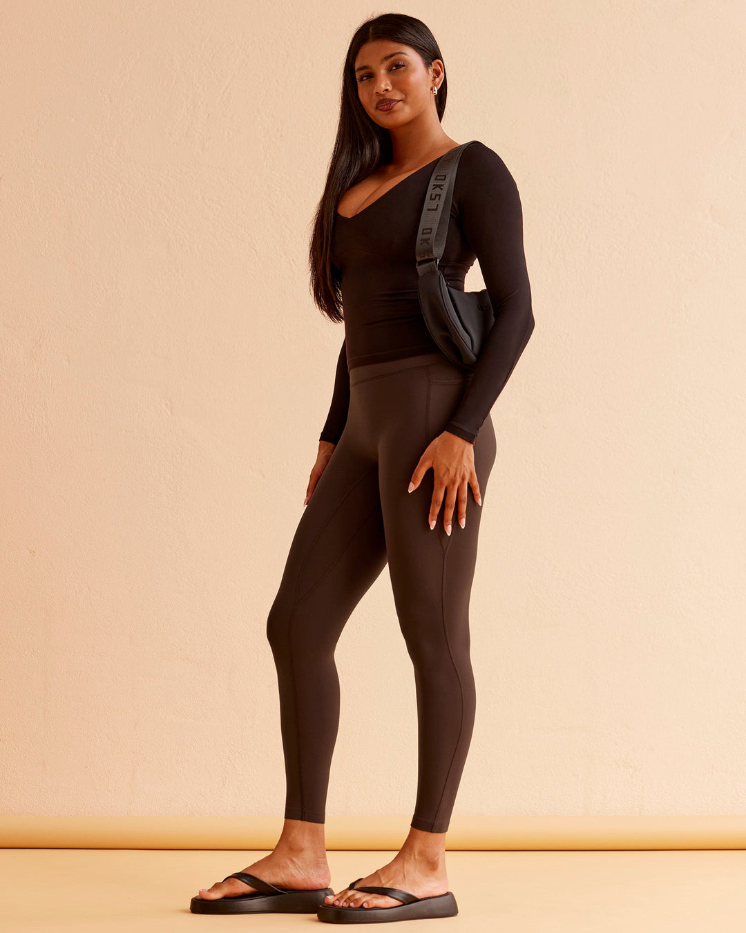 Woman wearing Vitality Long Sleeve Top - Black | Model:Nikki | Size:S