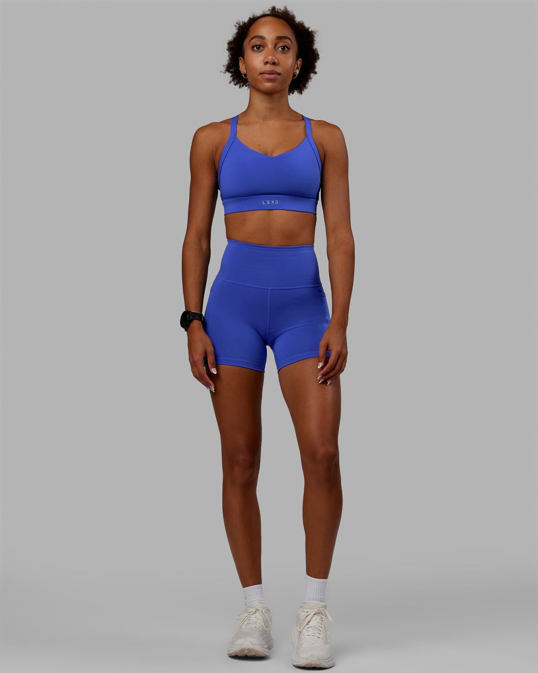 Woman wearing Flux Ultra High-Rise 4" Short Pockets - Power Cobalt