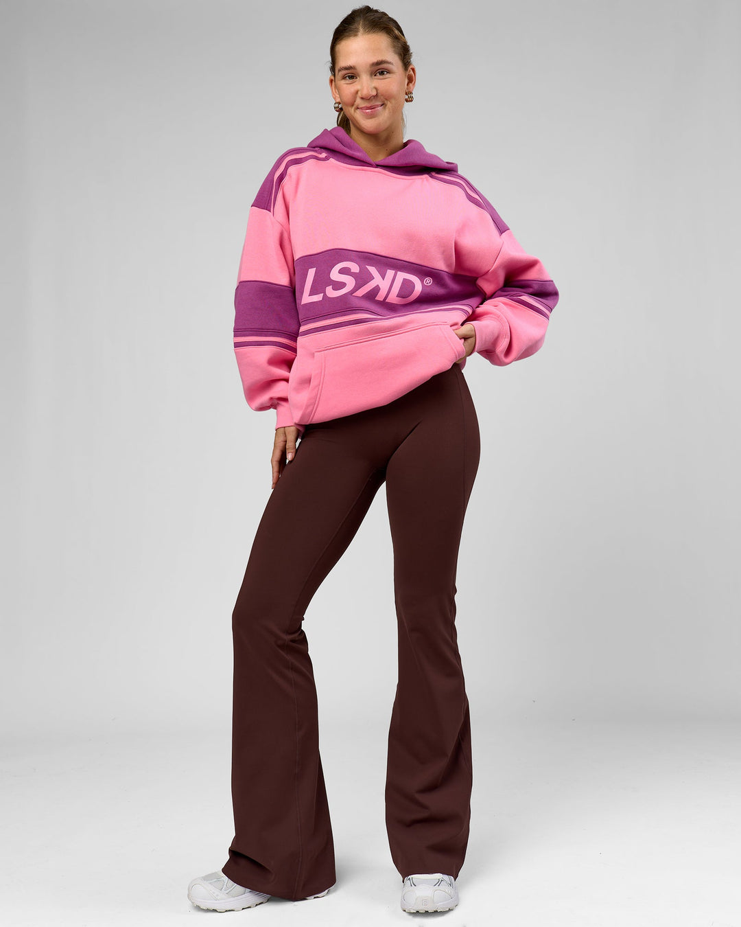 Woman wearing A-Team Oversized Hoodie - Candy Pink-Boysenberry | Model:Amity | Size:S