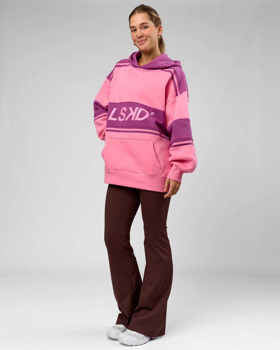 Woman wearing A-Team Oversized Hoodie - Candy Pink-Boysenberry | Model:Amity | Size:S