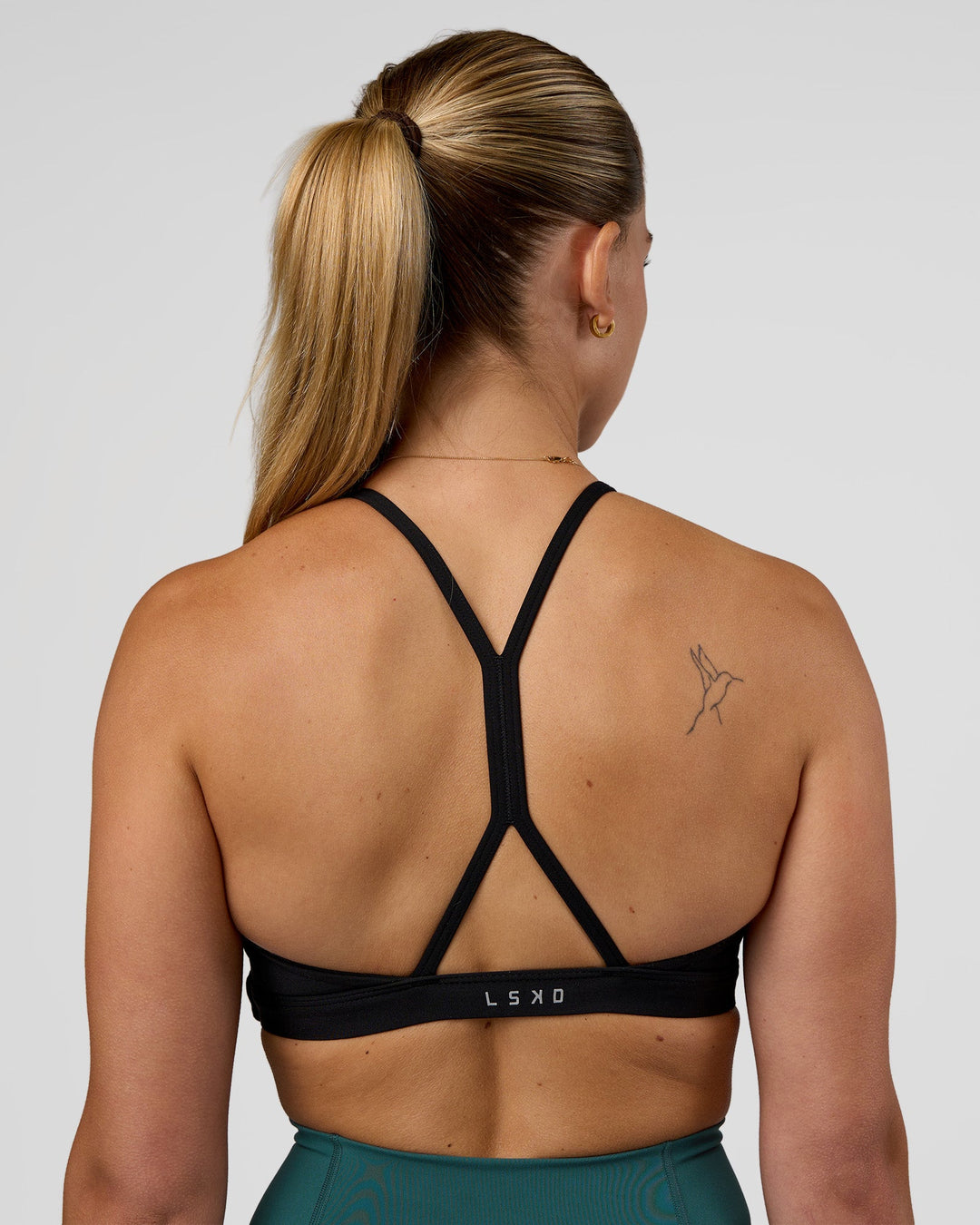 Woman wearing AMRAP High Neck Sports Bra - Black | Model:Myrte | Size:S - view 6