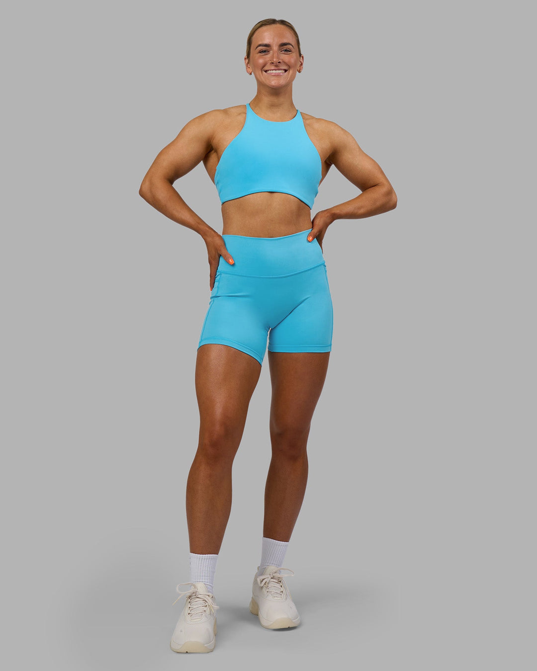 Woman wearing AMRAP High Neck Sports Bra - Blue Atoll | Model:Georgia | Size:S