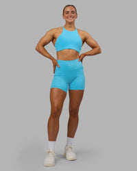 Woman wearing AMRAP High Neck Sports Bra - Blue Atoll | Model:Georgia | Size:S