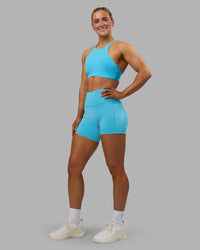 Woman wearing AMRAP High Neck Sports Bra - Blue Atoll | Model:Georgia | Size:S