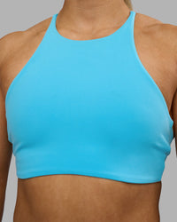 Woman wearing AMRAP High Neck Sports Bra - Blue Atoll | Model:Georgia | Size:S