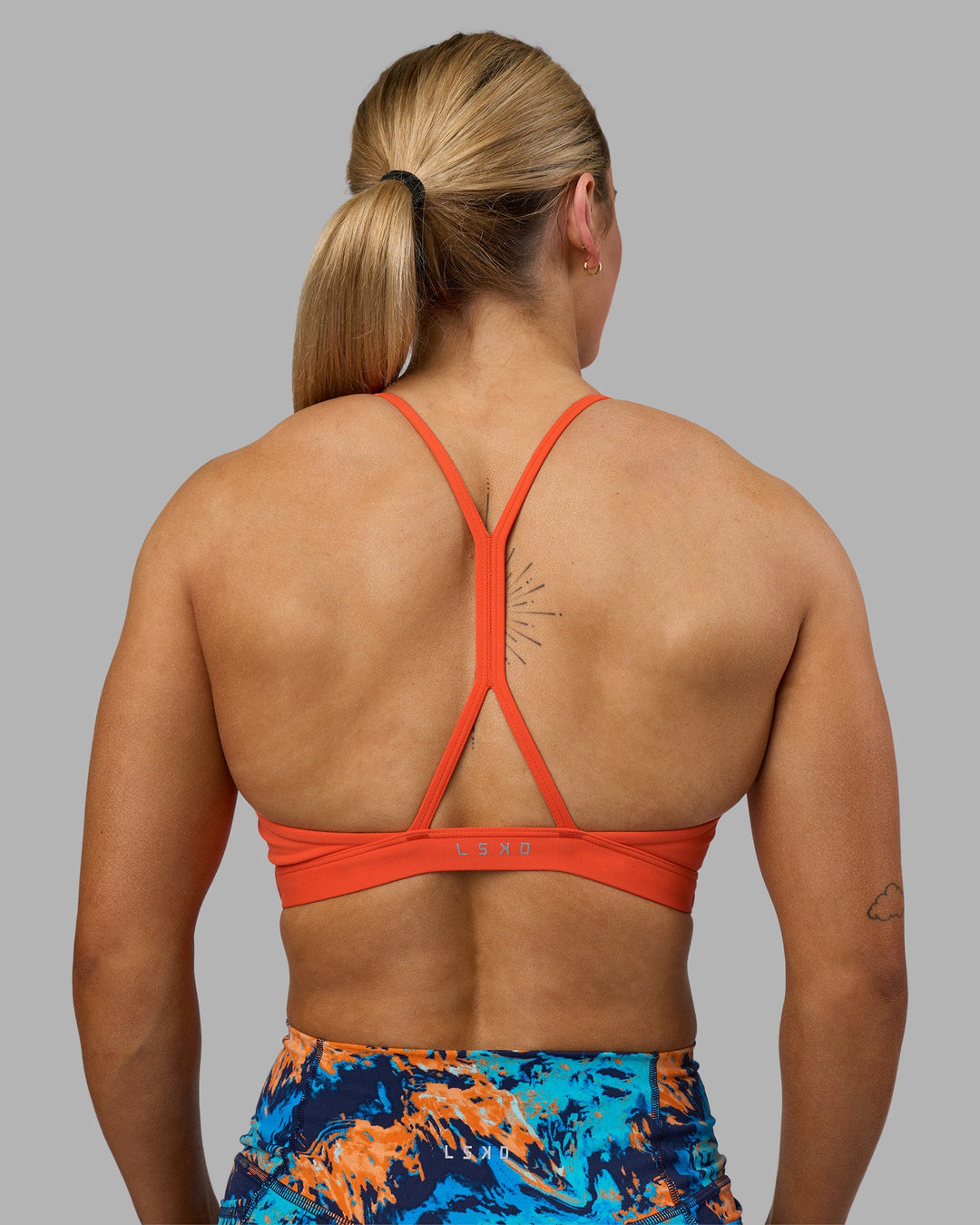 Woman wearing AMRAP High Neck Sports Bra - Ultra Orange | Model:Georgia | Size:S