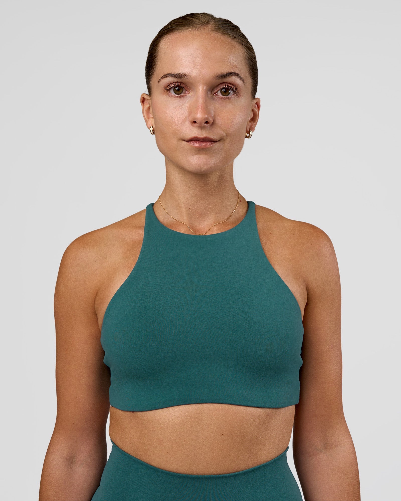 Woman wearing AMRAP High Neck Sports Bra - Transformative Teal | Model:Myrte | Size:S