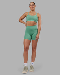 Woman wearing Abs Fusion High-Rise 6" Short Pockets - Matcha Green | Model:Abbey | Size:S