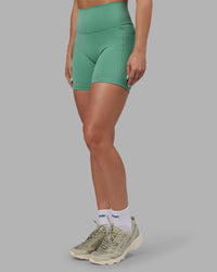 Woman wearing Abs Fusion High-Rise 6" Short Pockets - Matcha Green | Model:Abbey | Size:S