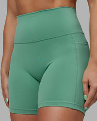 Woman wearing Abs Fusion High-Rise 6" Short Pockets - Matcha Green | Model:Abbey | Size:S
