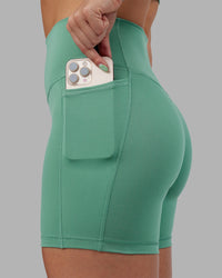 Woman wearing Abs Fusion High-Rise 6" Short Pockets - Matcha Green | Model:Abbey | Size:S