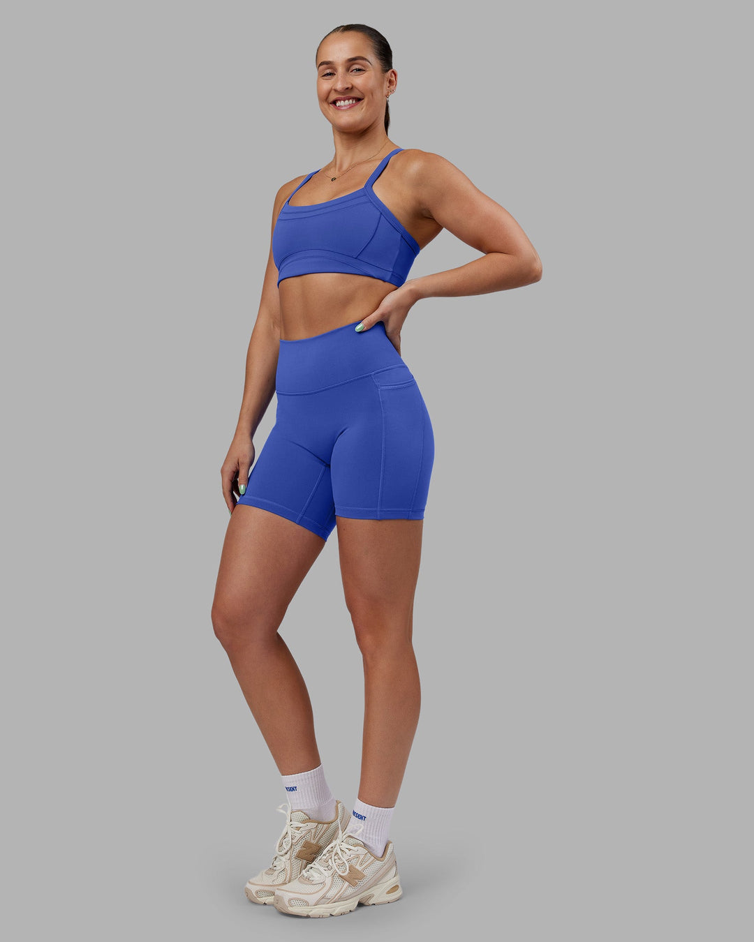 Woman wearing Abs Fusion High-Rise 6&quot; Short Pockets - Power Cobalt | Model:Abbey | Size:S