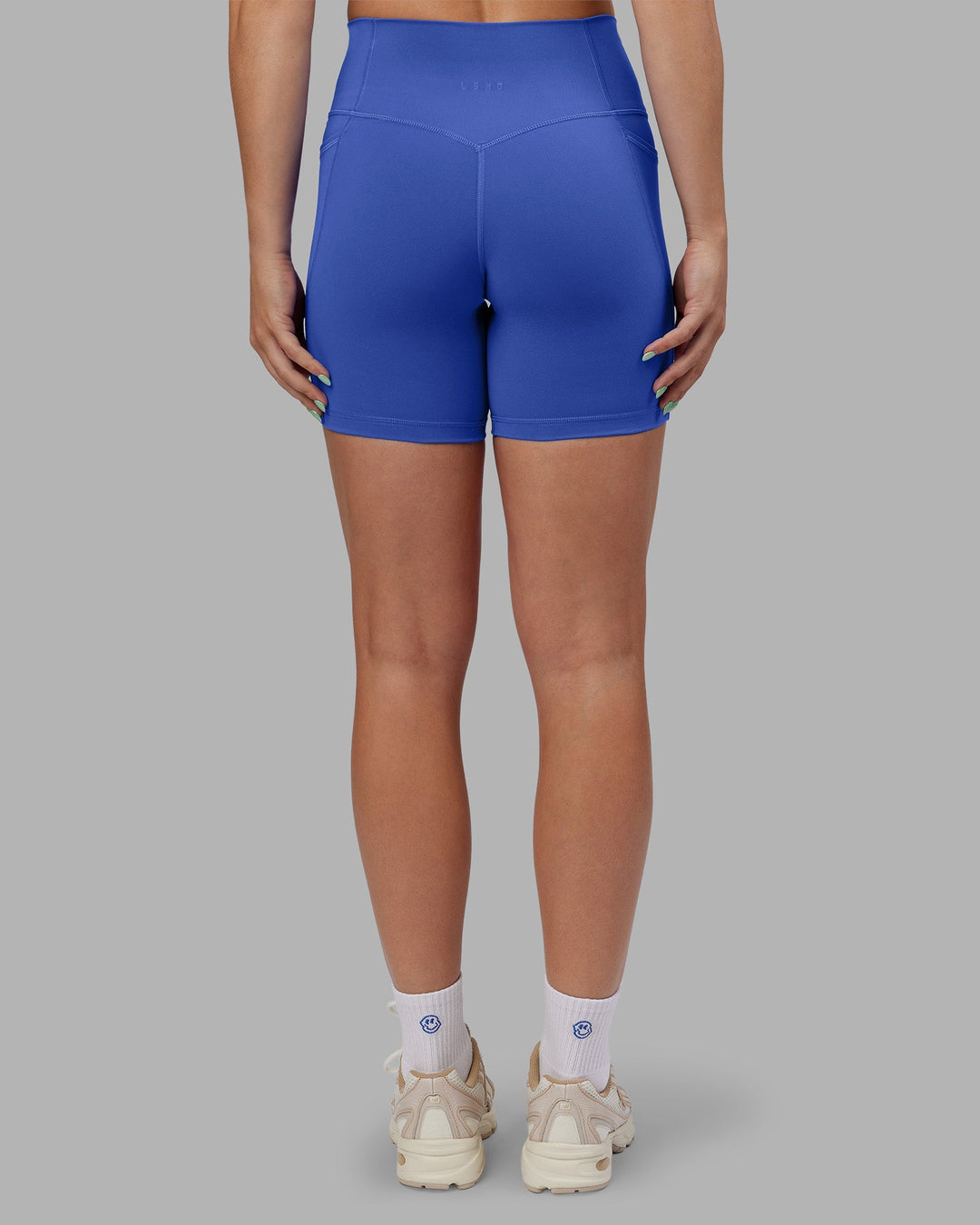 Woman wearing Abs Fusion High-Rise 6&quot; Short Pockets - Power Cobalt | Model:Abbey | Size:S