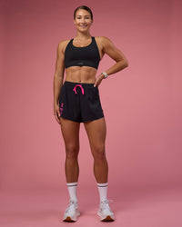 Woman wearing Accelerate 3" High-Rise Running Short - Black-Ultra Pink | Model:Hannah | Size:S