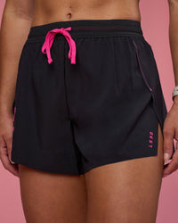 Woman wearing Accelerate 3" High-Rise Running Short - Black-Ultra Pink | Set:true | Angle:closeup | Model:Hannah | Size:S