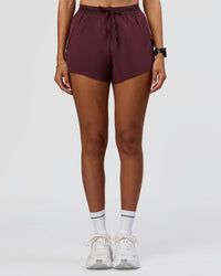 Woman wearing Accelerate 3" High-Rise Running Short - Cherry Lacquer | Model:Rhiley | Size:S