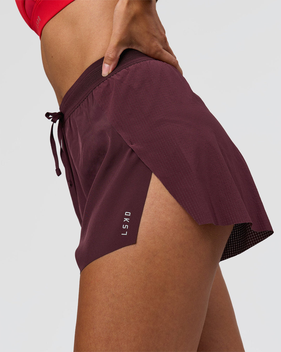 Woman wearing Accelerate 3" High-Rise Running Short - Cherry Lacquer | Model:Rhiley | Size:S