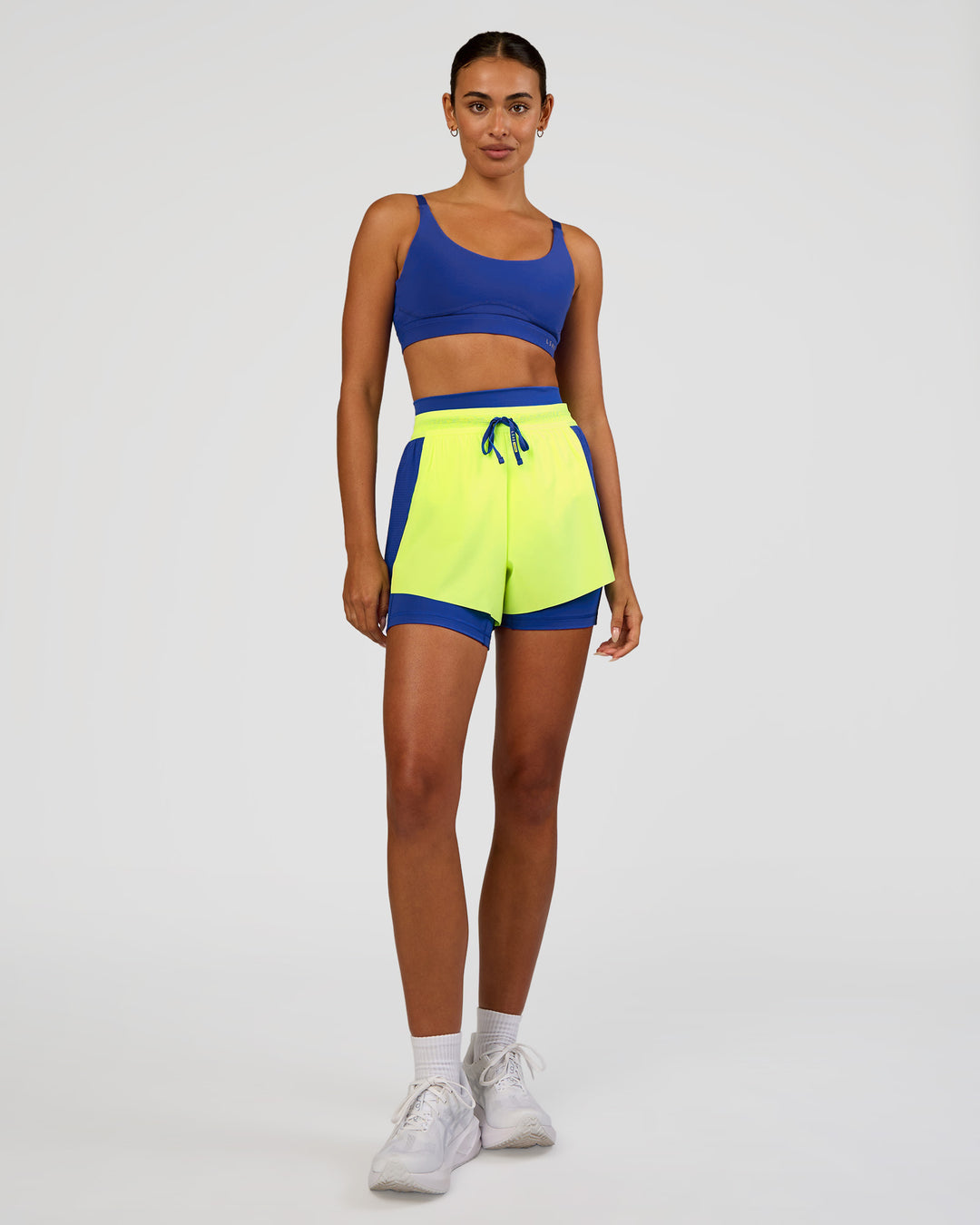 Woman wearing Accelerate 3" High-Rise Running Short - Electric Indigo-Lime Glo | Model:Ruby | Size:S