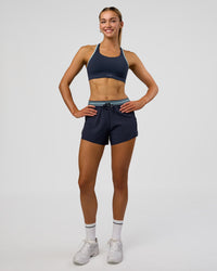 Woman wearing Accelerate 3" High-Rise Running Short - Future Navy-Baltic Sea | Model:Evie | Size:S