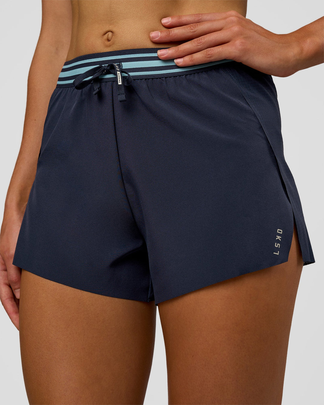Woman wearing Accelerate 3" High-Rise Running Short - Future Navy-Baltic Sea | Set:true | Angle:closeup | Model:Evie | Size:S