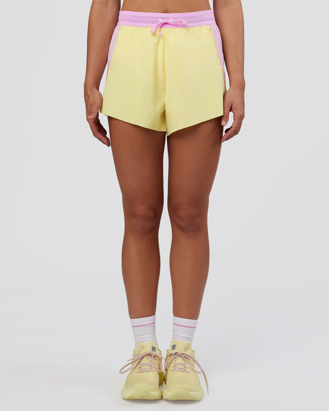 Woman wearing Accelerate 3" High-Rise Running Short - Marshmallow-Lemon | Set:true | Angle:front | Model:Grace | Size:S