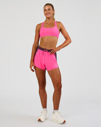 Woman wearing Accelerate 3" High-Rise Running Short - Midnight Plum-Sugar Plum | Model:Emelia | Size:S