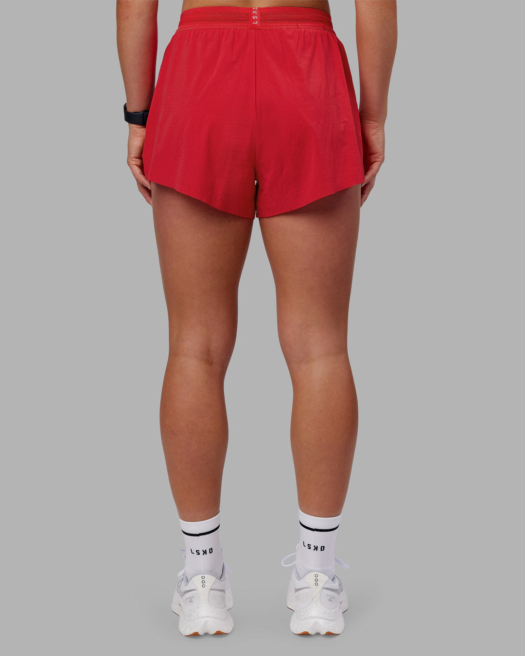 Woman wearing Accelerate 3" High-Rise Running Short - Scarlet | Set:true | Angle:back | Model:Keisha | Size:S
