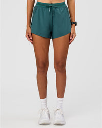 Woman wearing Accelerate 3" High-Rise Running Short - Transformative Teal | Set:true | Angle:front | Model: Rhiley | Size:S