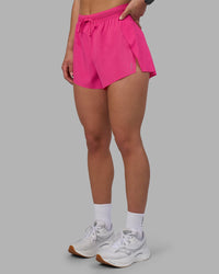 Woman wearing Accelerate 3" High-Rise Running Short - Ultra Pink | Set:true | Angle:side | Model:Keisha | Size:S