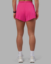 Woman wearing Accelerate 3" High-Rise Running Short - Ultra Pink | Set:true | Angle:back | Model:Keisha | Size:S