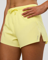 Woman wearing Accelerate 3" High-Rise Running Short - Yellow Fizz | Set:true | Angle:closeup | Model:Evie | Size:S