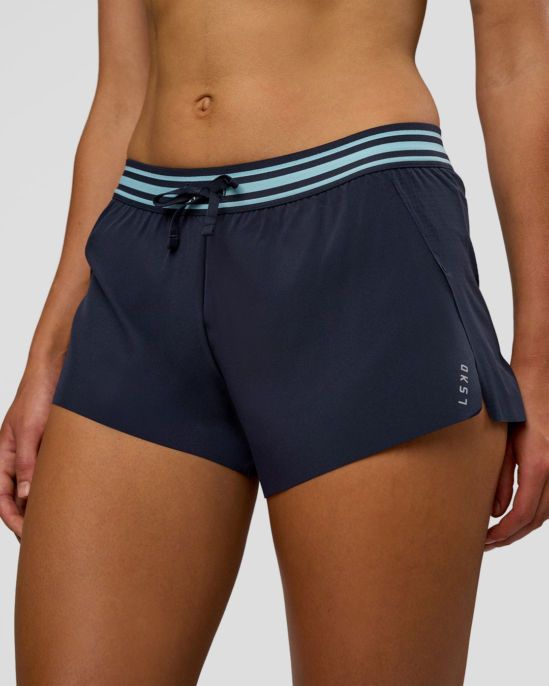 Woman wearing Accelerate 3" Mid-Rise Running Short - Future Navy-Baltic Sea | Model:Evie | Size:S